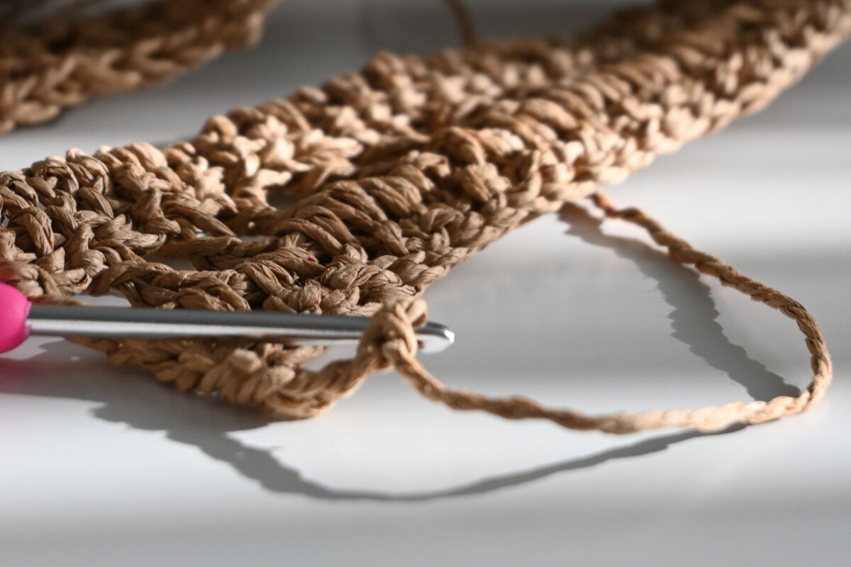 The foundation chain and first rows of a crochet wheat stitch pumpkin on the hook, the stage where the multiple has to be right