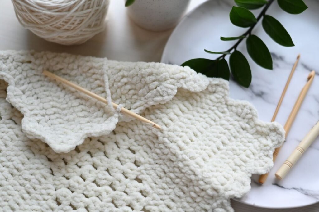 Wooden crochet hooks and yarn wound ready to start a crochet star blanket
