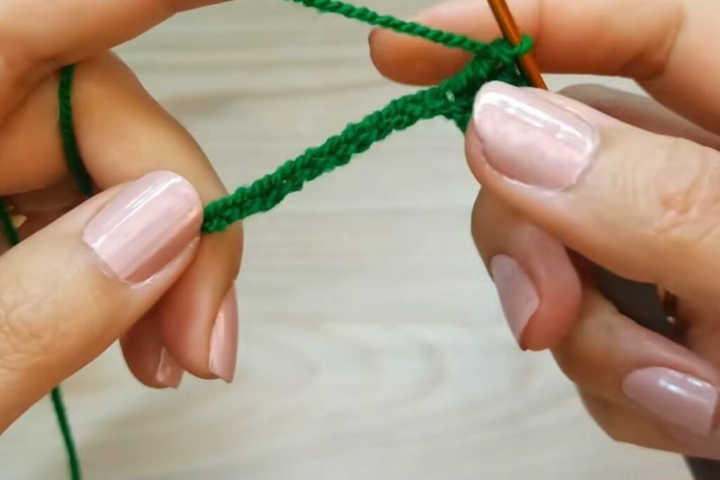Double crochet worked along the starting chain of a crochet christmas tree gift bag
