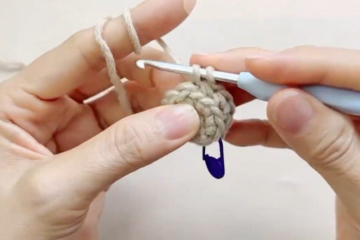round 3 of a free crochet pinecone pattern worked in the back loop only