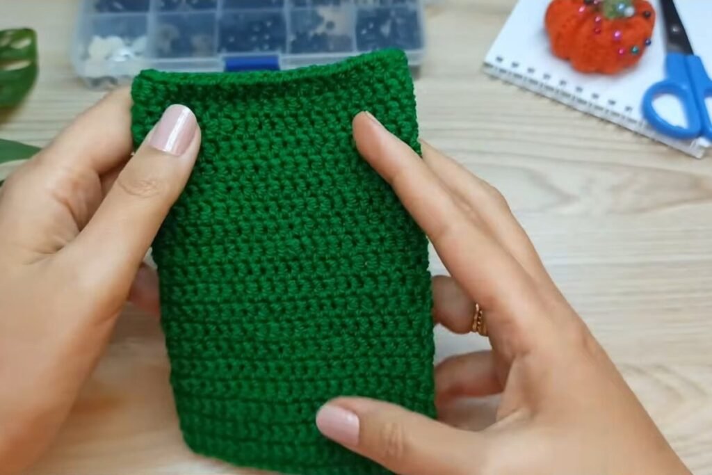 Finished green crochet gift bag body after 20 rounds of double crochet