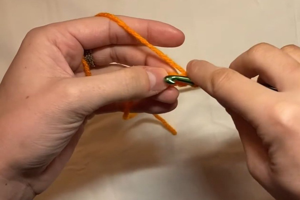 crocheting the orange nose for a free crochet snowman pattern