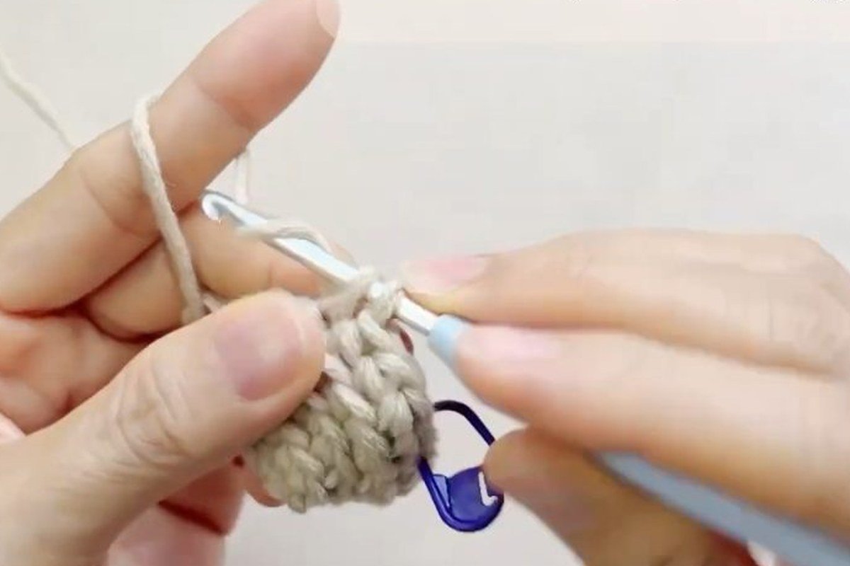 round 5 of a free crochet pinecone pattern with a plain round of single crochet