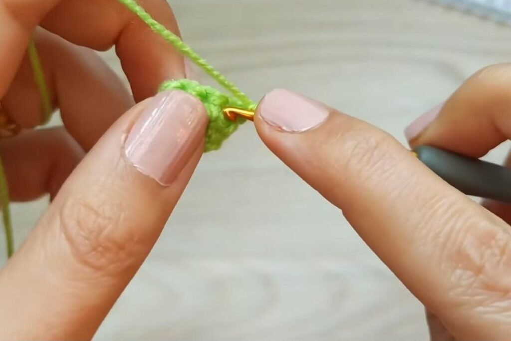 Tip of the light green crochet christmas tree worked in single crochet increase rows