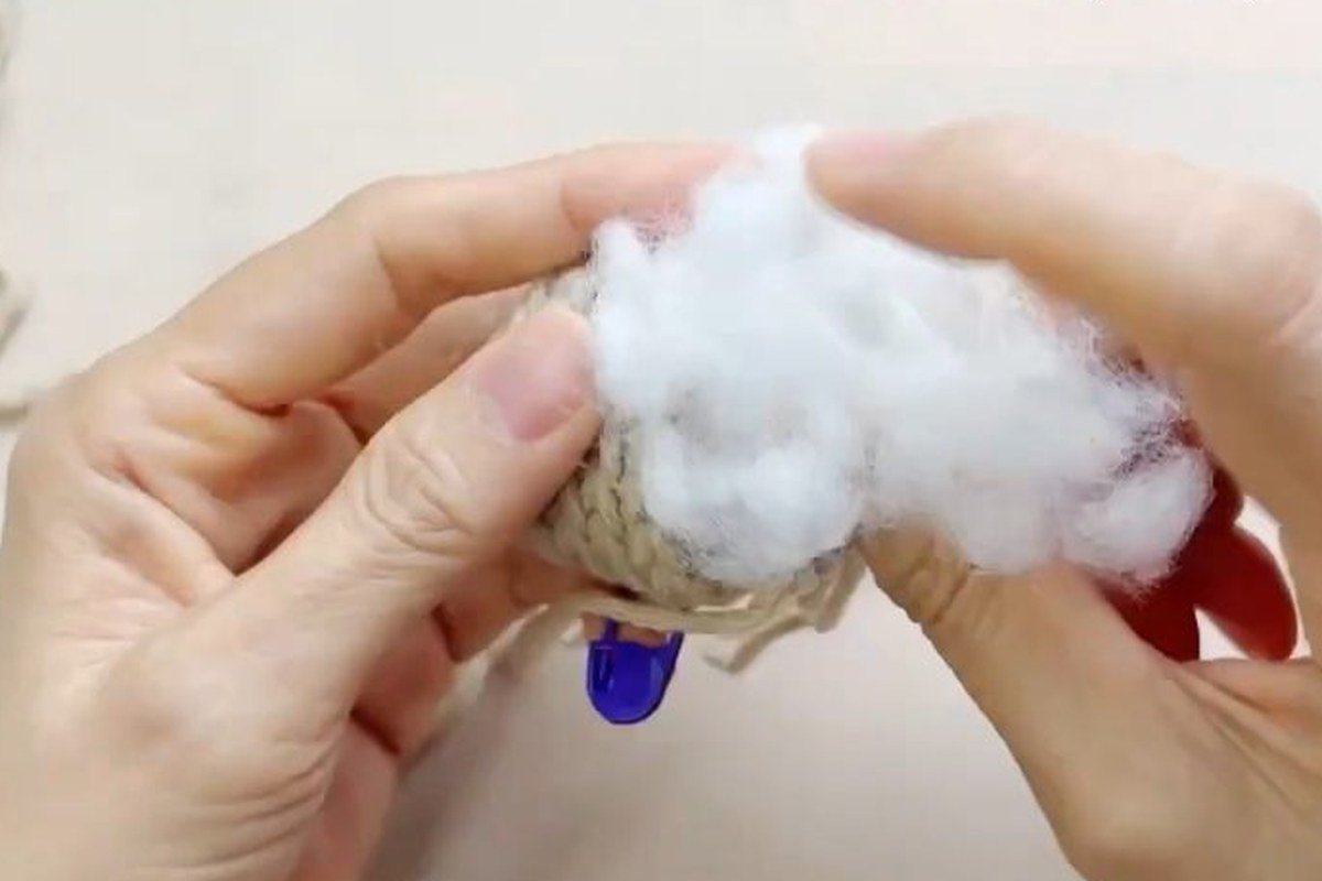 stuffing the core of a free crochet pinecone pattern with fiberfill