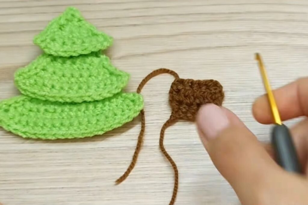 Three stacked tree tiers and a small brown crochet tree trunk
