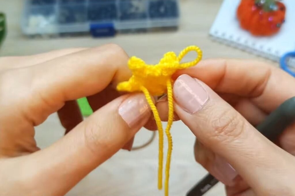 Small yellow five point crochet star for the top of the tree