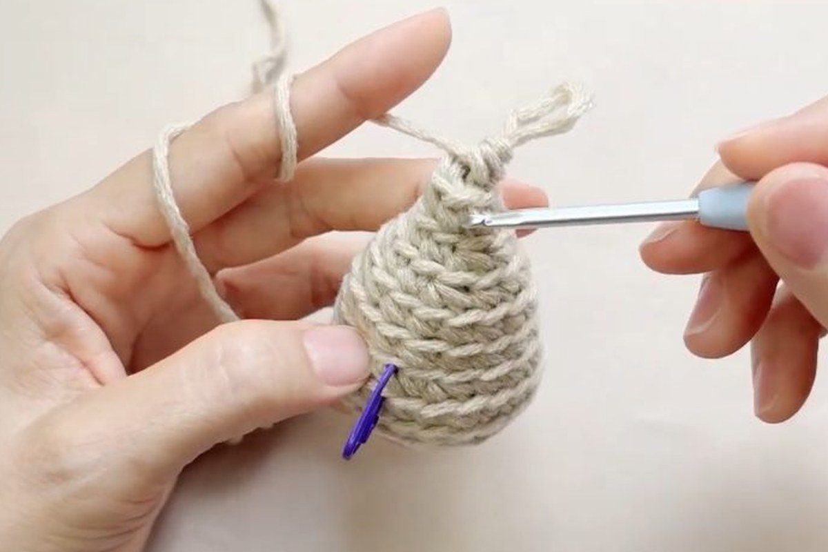 finished stuffed core of a free crochet pinecone pattern before the scales