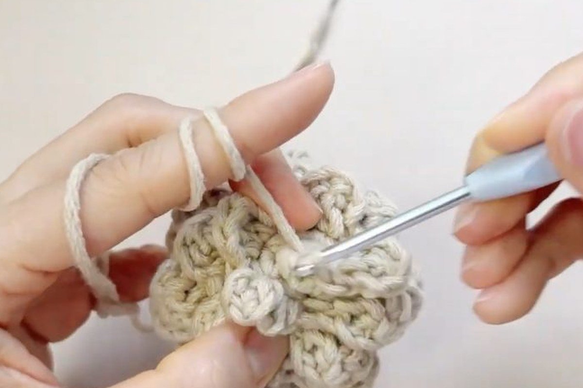 top scales of a free crochet pinecone pattern finished with a slip stitch in the centre