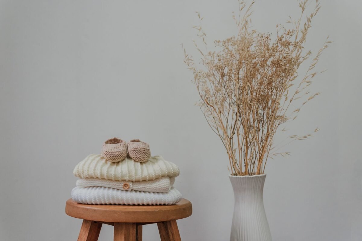 Mercerised cotton yarn for a crochet baby shoes free pattern arranged on a wooden stool