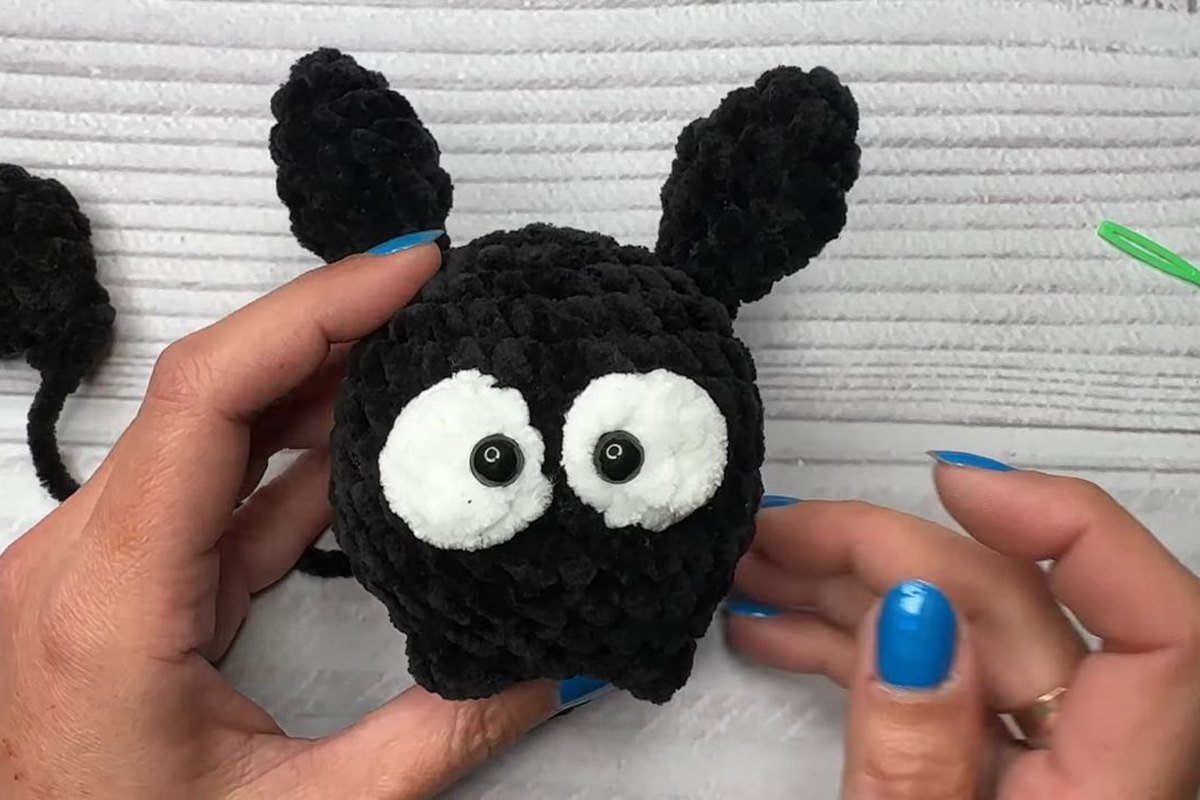 black crochet bat ears pinned to the top of the body