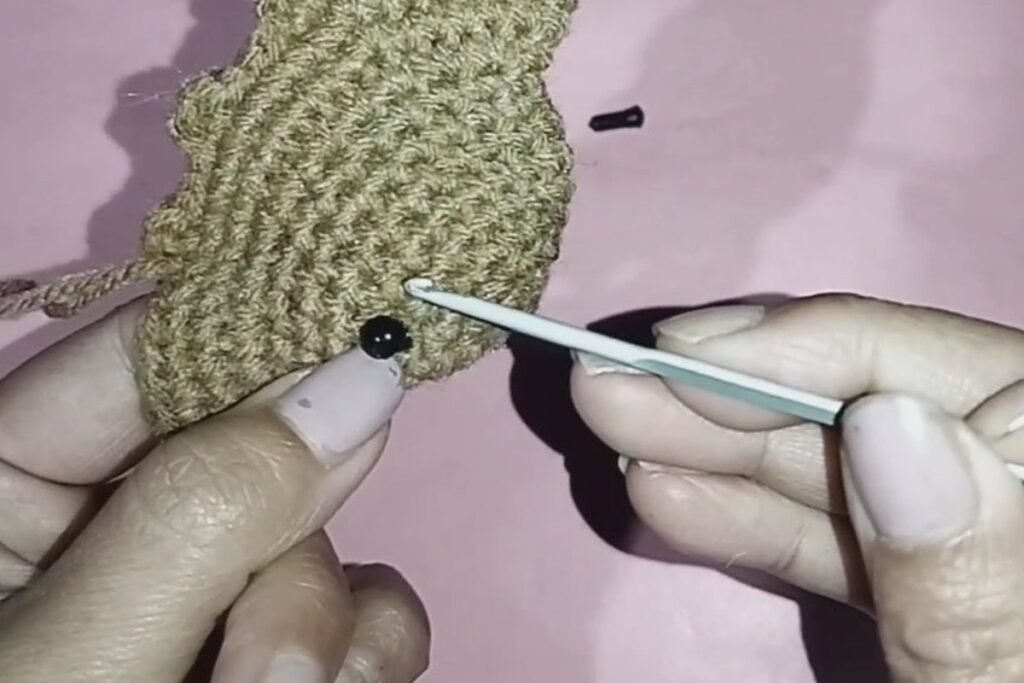 black eyes placed on a crochet bat keychain