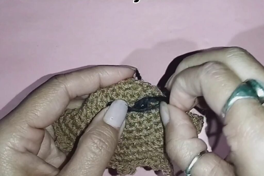 black yarn smile on a crochet bat keychain
