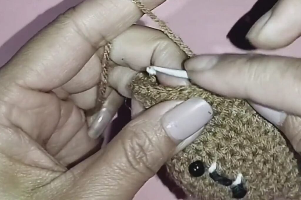 finishing the scalloped wings on a crochet bat keychain