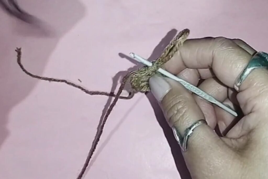 round 3 of a crochet bat keychain with increases every second stitch