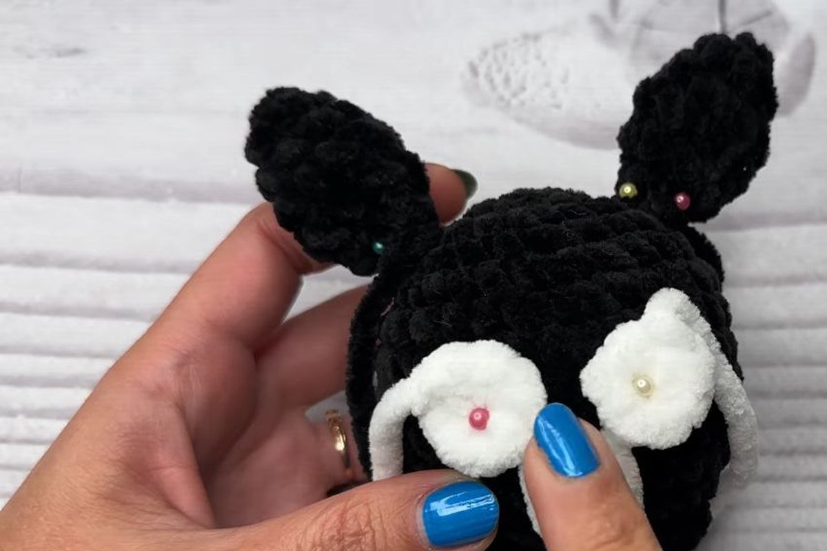 white eyes and black ears pinned onto a crochet bat body