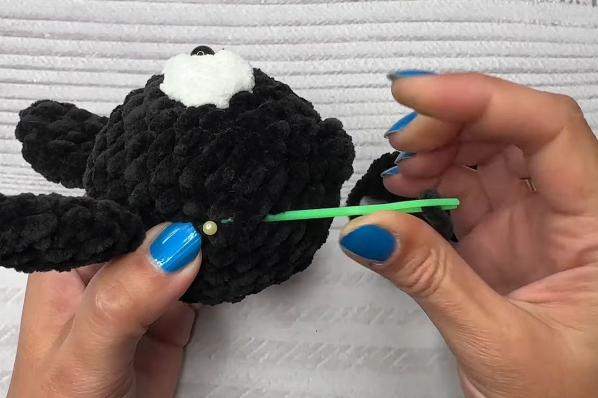 sewing a black crochet wing onto the side of the bat body