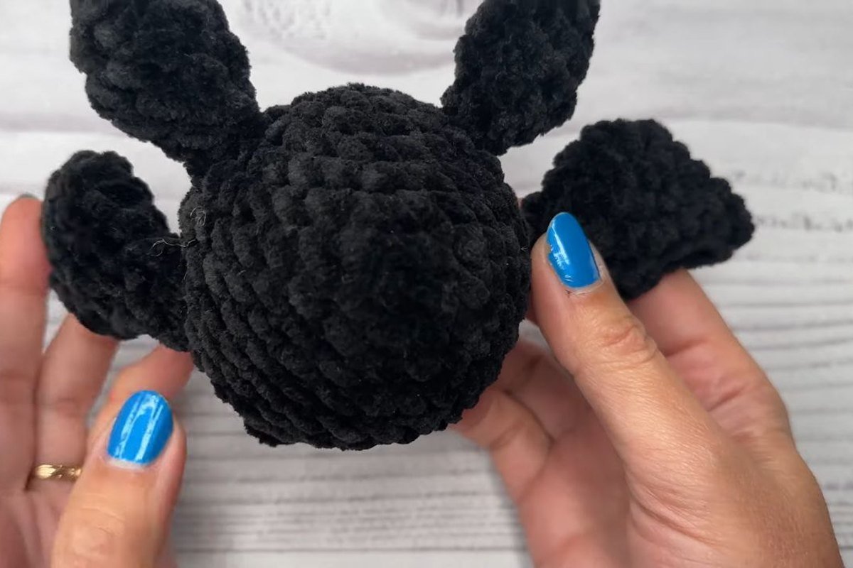 back view of a black free crochet bat pattern with both wings sewn on