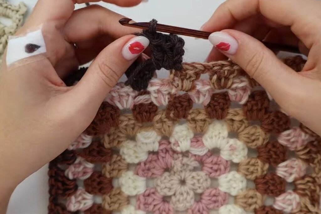working round 8 in brown, the main colour of the crochet granny square cardigan