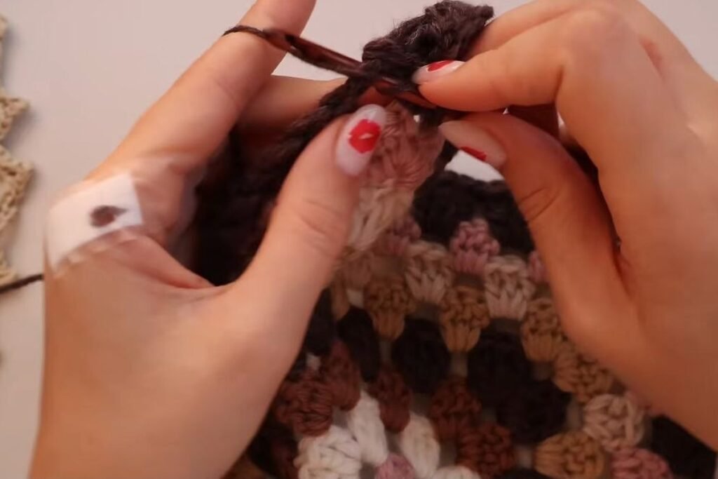 adding an extra row of double crochet clusters along the back panel edge