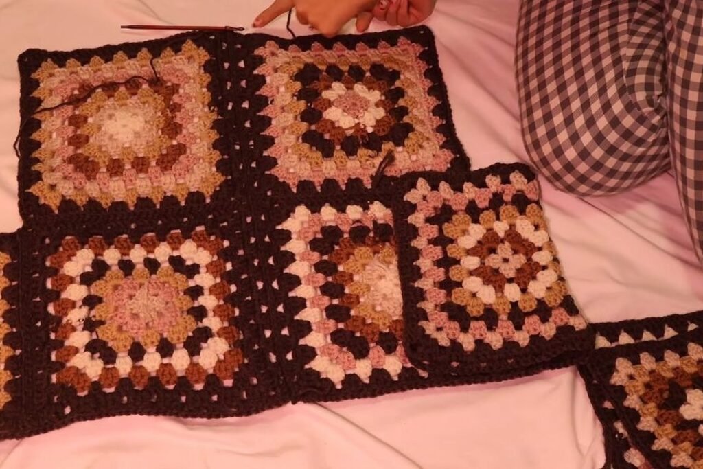 attaching the front squares of the crochet granny square cardigan to the joined back
