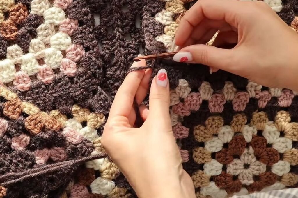 crocheting a two strand tie at the front of the crochet granny square cardigan