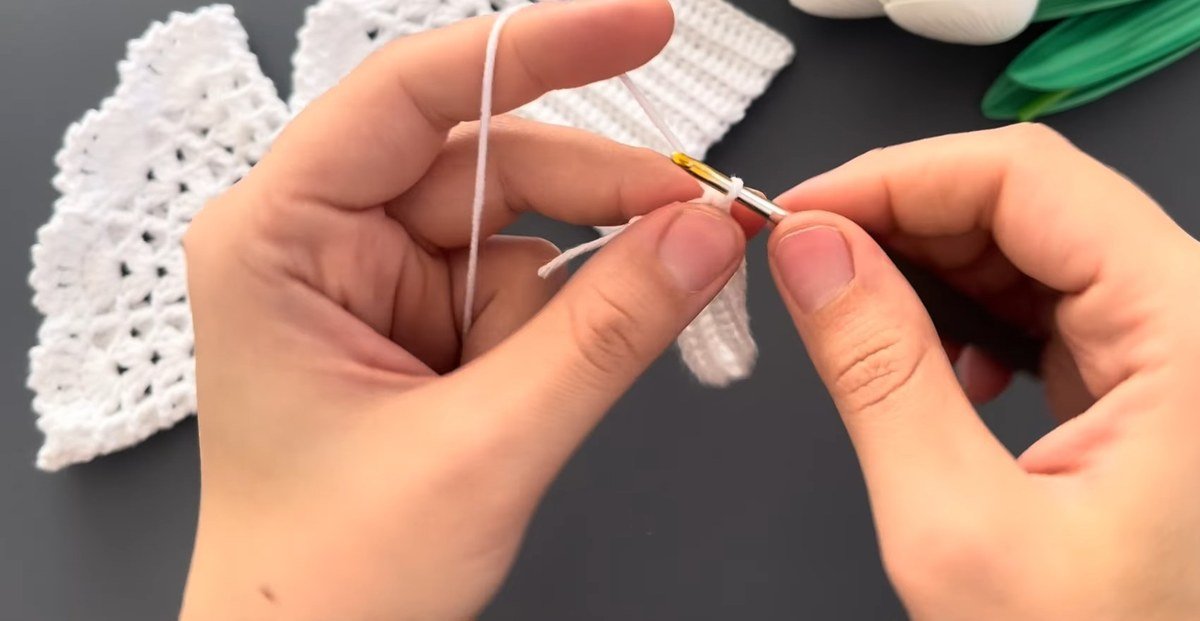 ribbed rows of single crochet growing on a hook for crochet lace wrist cuffs
