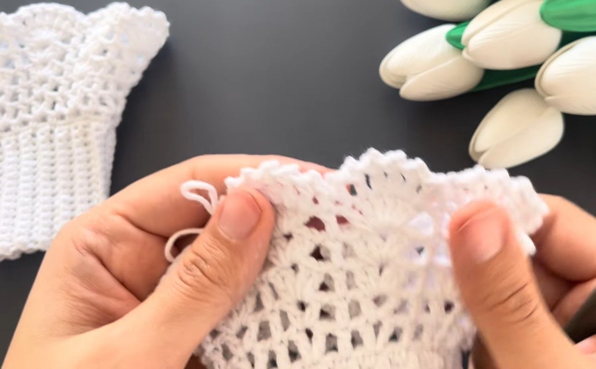 scalloped edge being finished on crochet lace wrist cuffs