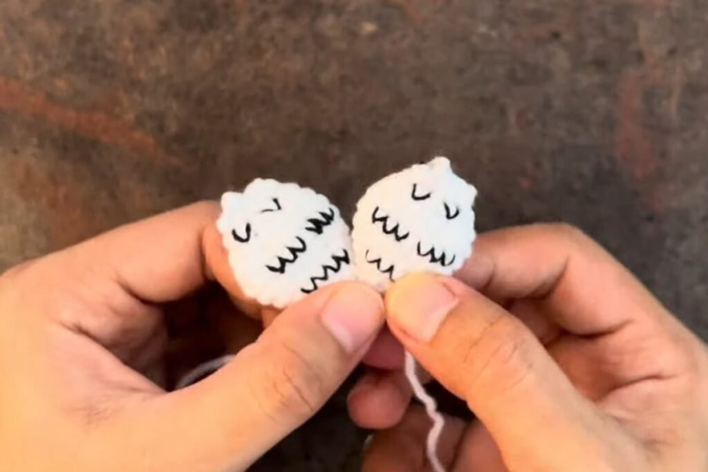crochet snowy owl pattern wings with black embroidered feather marks