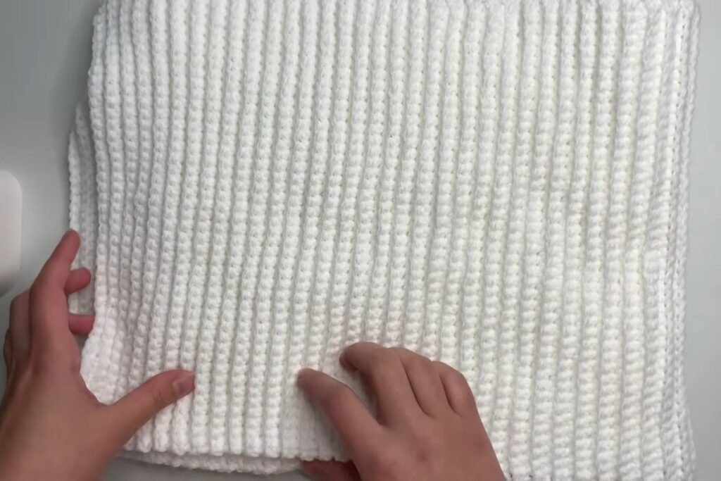 Finished easy crochet scarf pattern in white worsted yarn showing back loop single crochet ribs