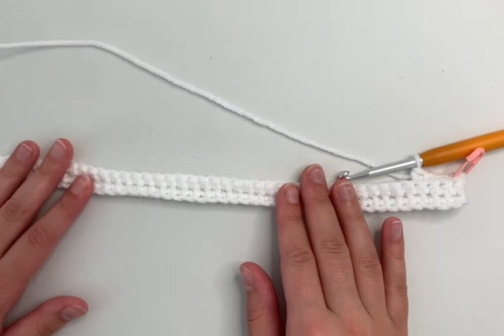 Crochet scarf growing row by row in back loop single crochet