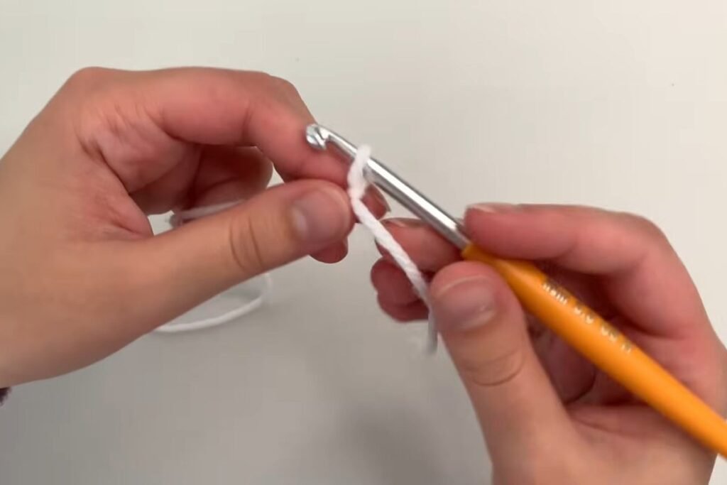 Slip knot tightened on a 5 mm crochet hook for the easy crochet scarf pattern