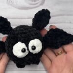 finished black crochet bat from a free crochet bat pattern with white eyes and small wings