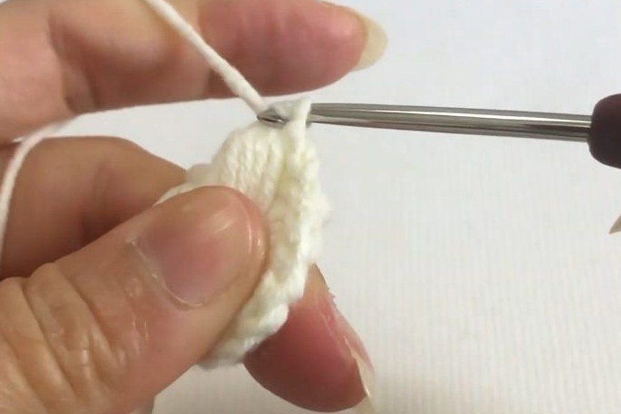 the first puff stitch finished in the ring of a puff stitch crochet snowflake
