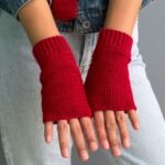red crochet fingerless gloves worn on both hands, made from a free crochet fingerless gloves pattern