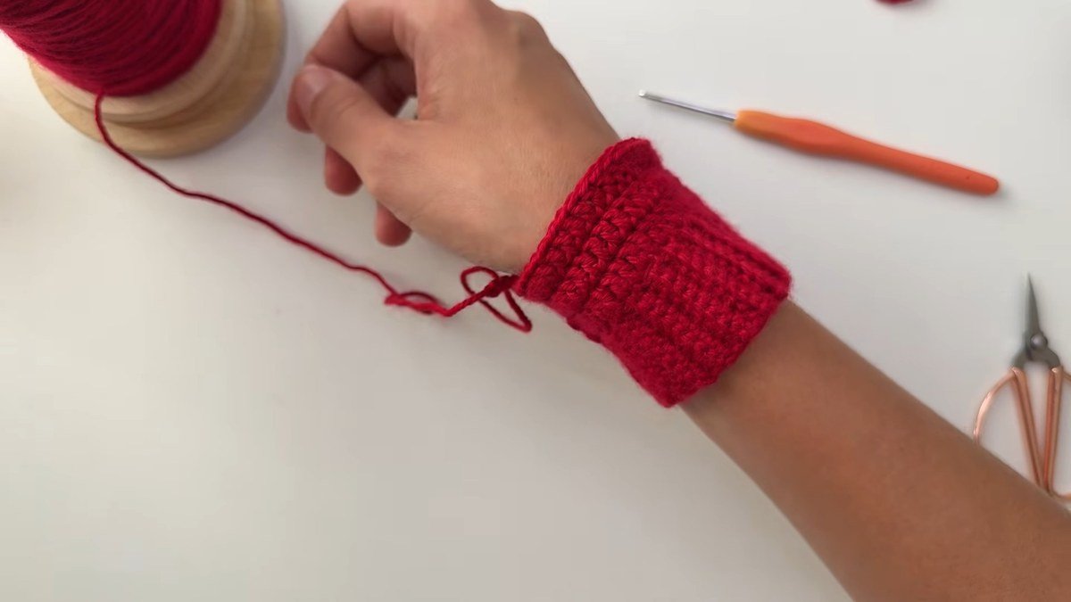 trying the finished ribbed cuff of a free crochet fingerless gloves pattern on the wrist