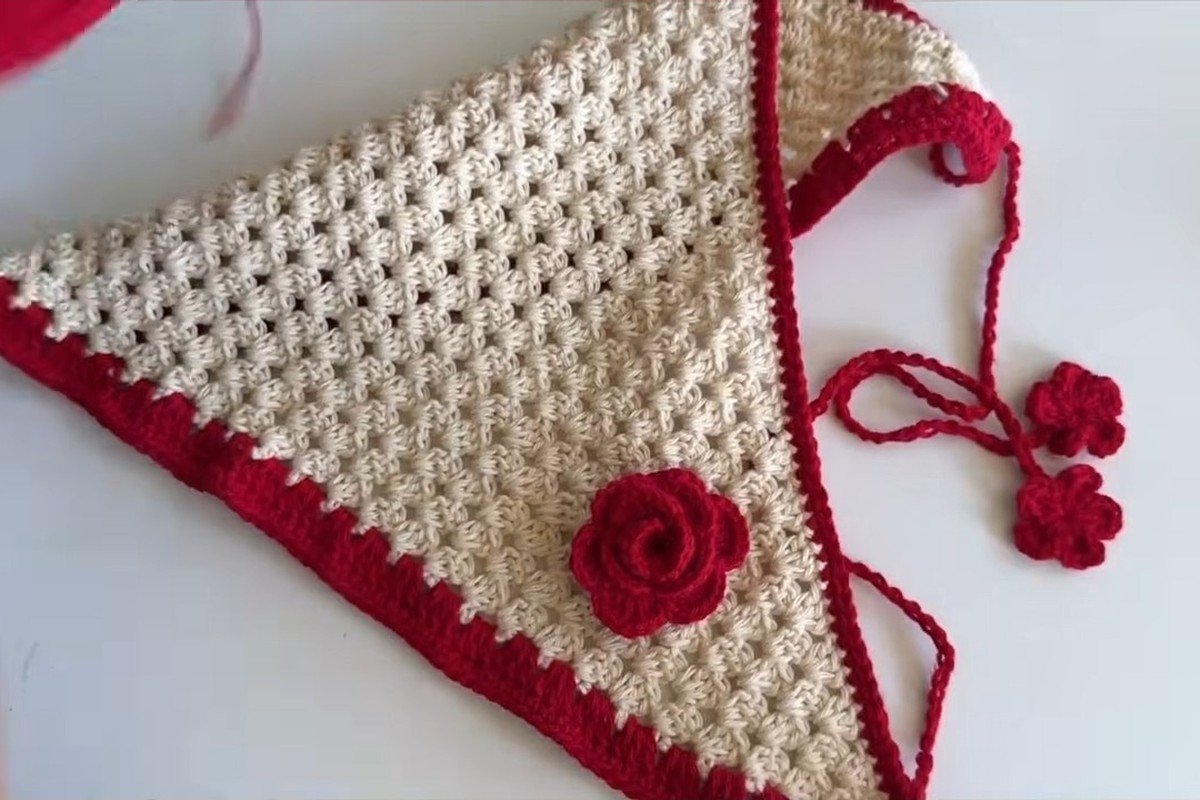 Finished free crochet head scarf pattern in cream cotton with red border, flower ties and a red crochet rose
