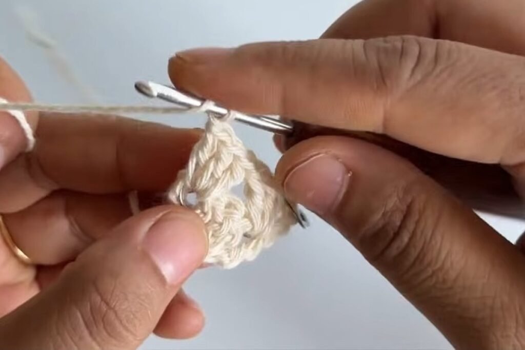 Treble crochet into the marked chain at the corner of the crochet head scarf