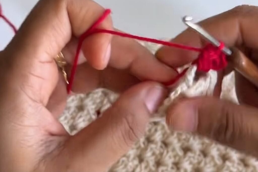 Red border of three double crochet in each side space of the crochet head scarf