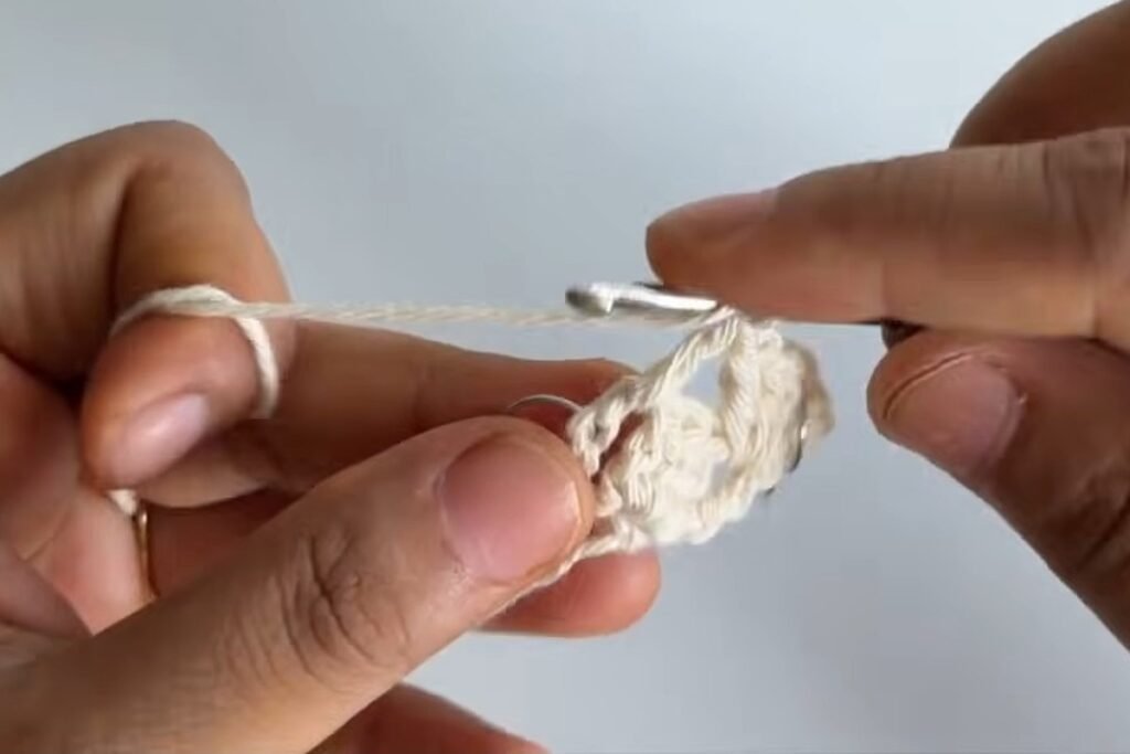 Working three double crochet into each space of row 2 of the free crochet head scarf pattern