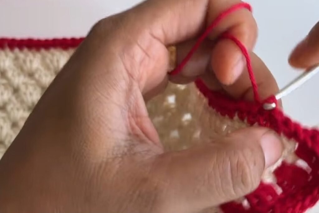 Slip stitches along the front edge of the red border