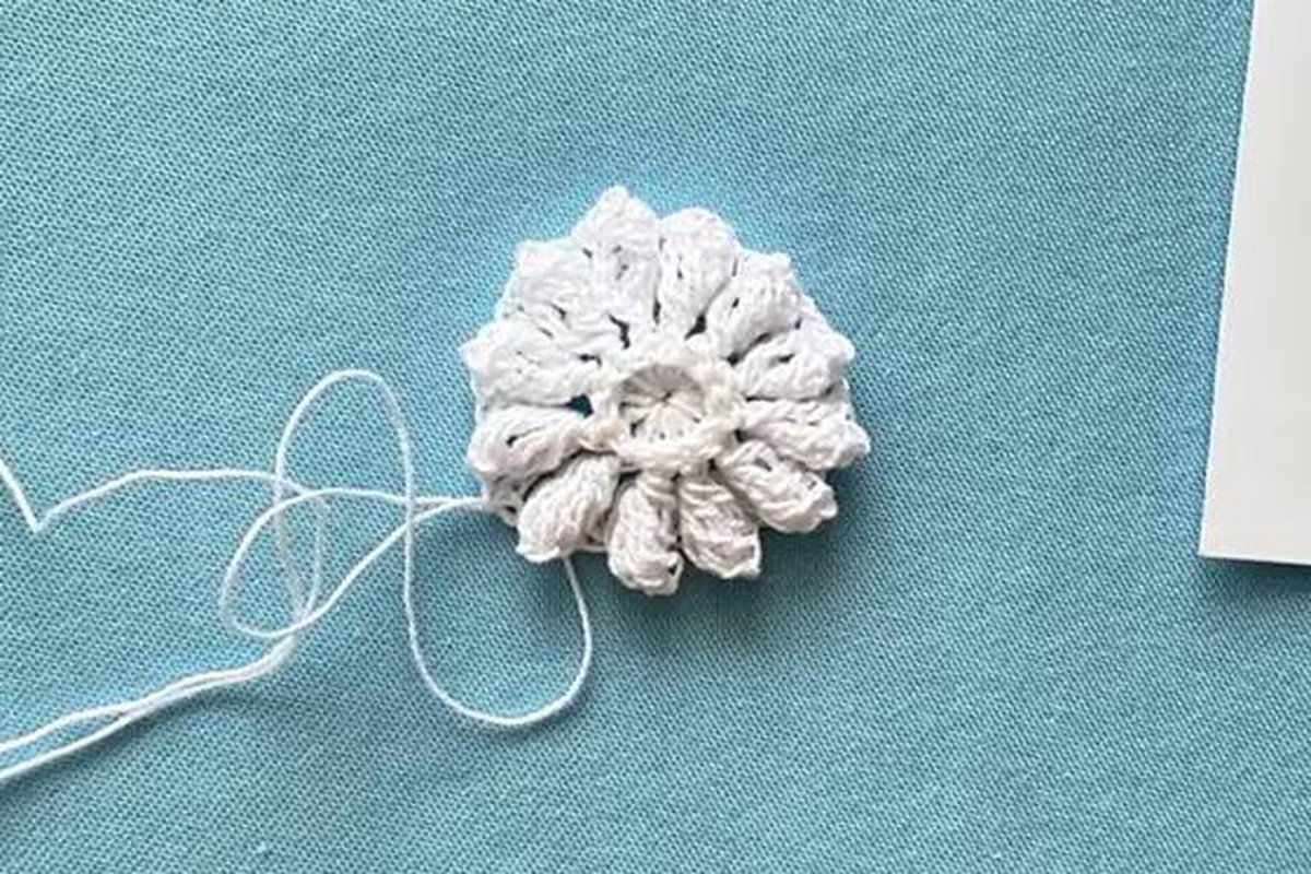 raised twelve petal flower centre of a free crochet snowflake pattern