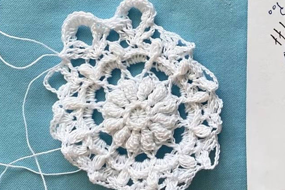 free crochet snowflake pattern after round 9 with raised ribs and open arches
