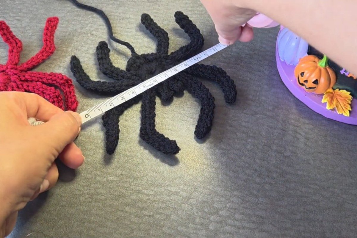 measuring a flat crochet spider with a tape measure for a free crochet spider pattern