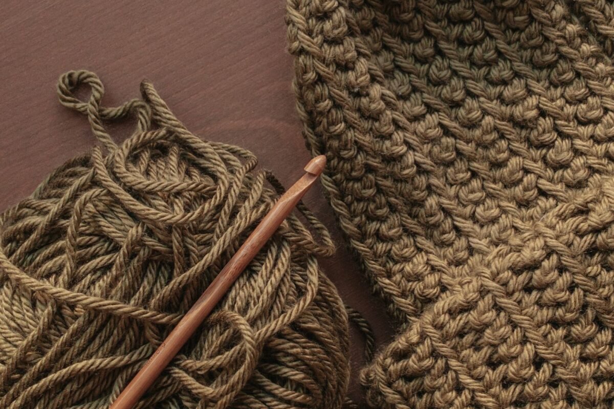 The dense fabric a crochet hat for men needs, worked in olive worsted yarn with a wooden crochet hook