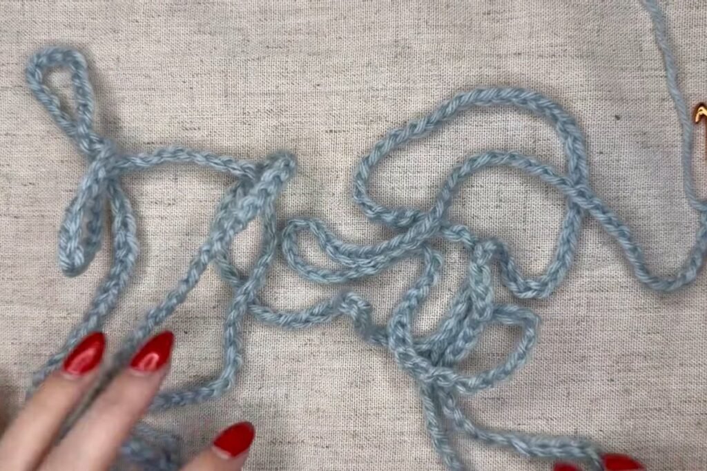 moss stitch crochet scarf starting chain of 300 in blue yarn