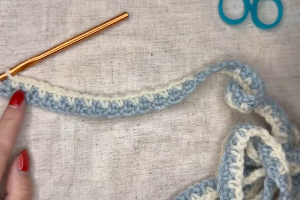 two rows of moss stitch in blue and cream on the hook