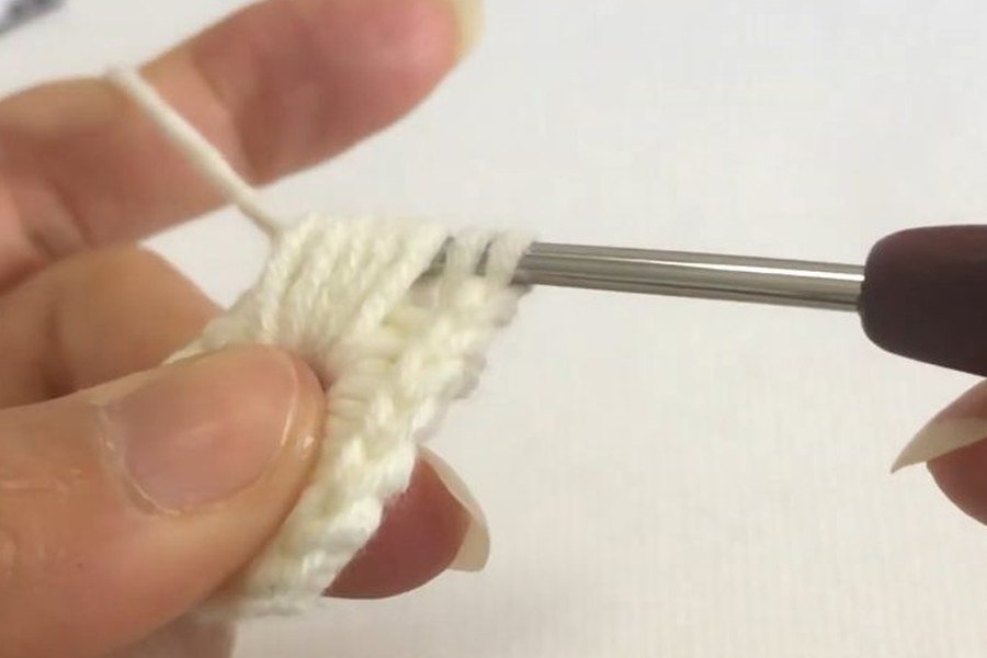 pulling through all loops closes the puff stitch of a puff stitch crochet snowflake