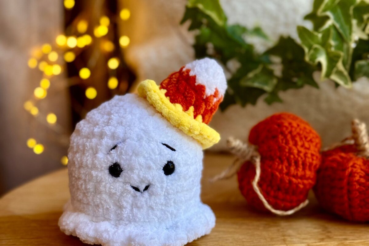 Crocheted pumpkins in orange with twine stems, the stuffed form a pumpkin granny square pattern can take