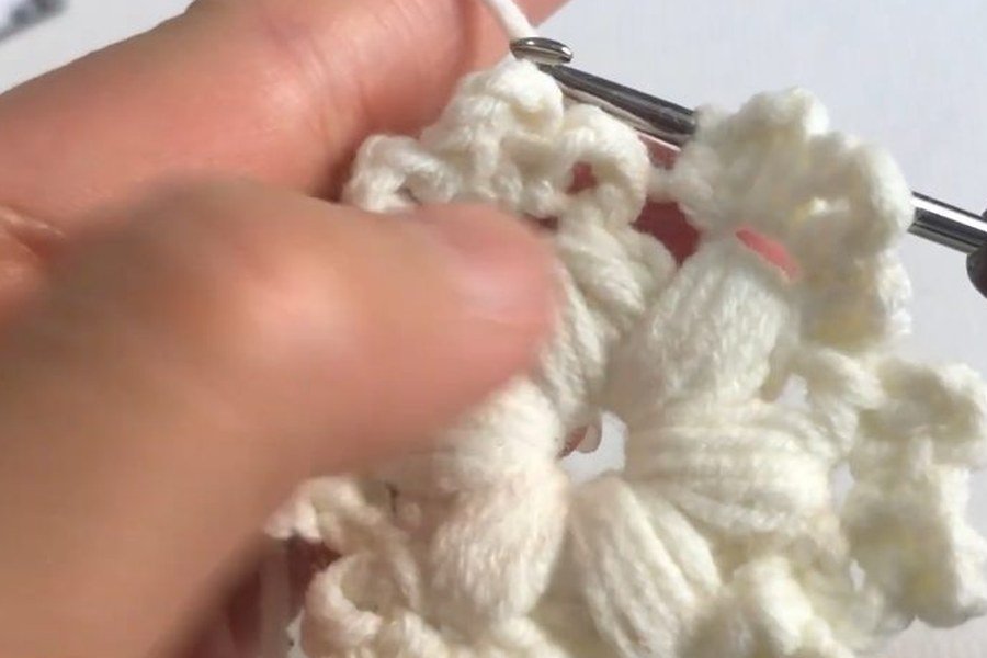 six puff stitch points cover the ring of a puff stitch crochet snowflake